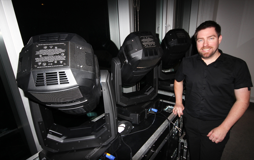 Technician beside large Robe BMFL fixtures used for the Seven News launch.