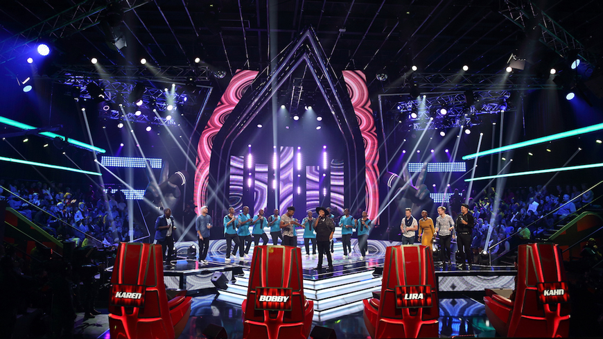 The Voice South Africa final stage with red judges' chairs and large illuminated frames.