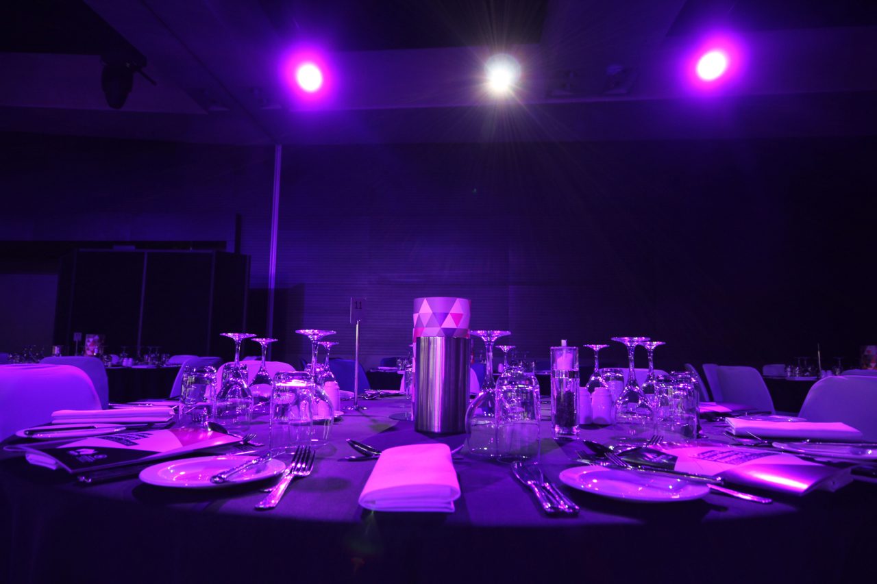 Purple lighting over a banquet table at Adelaide Convention Centre.