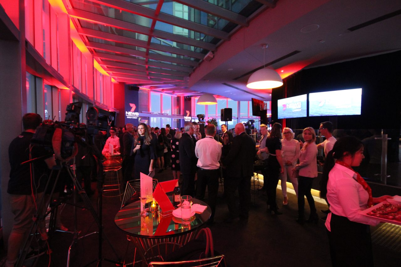 Red lighting and a presentation screen above guests at the Channel 7 News Gold Coast launch.