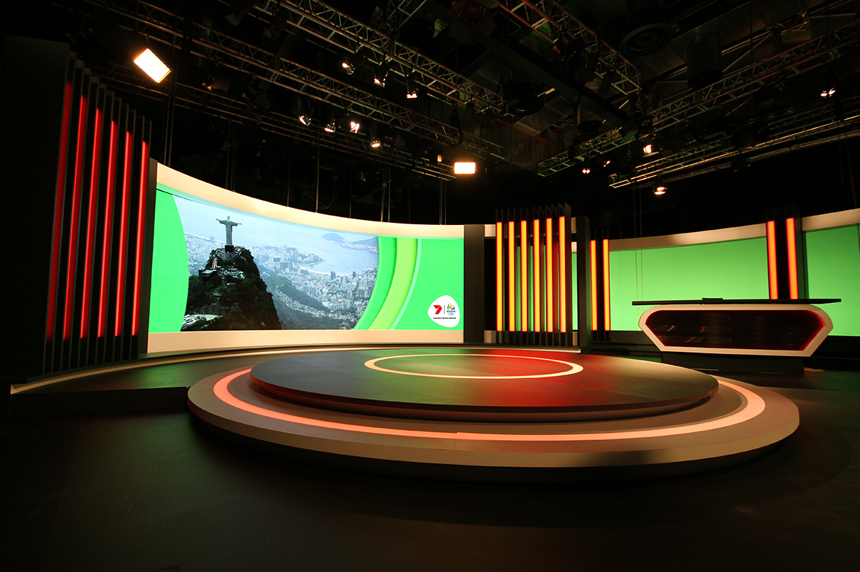 Wide view of Channel 7's Rio Olympic studio with curved screens and illuminated stage edges.