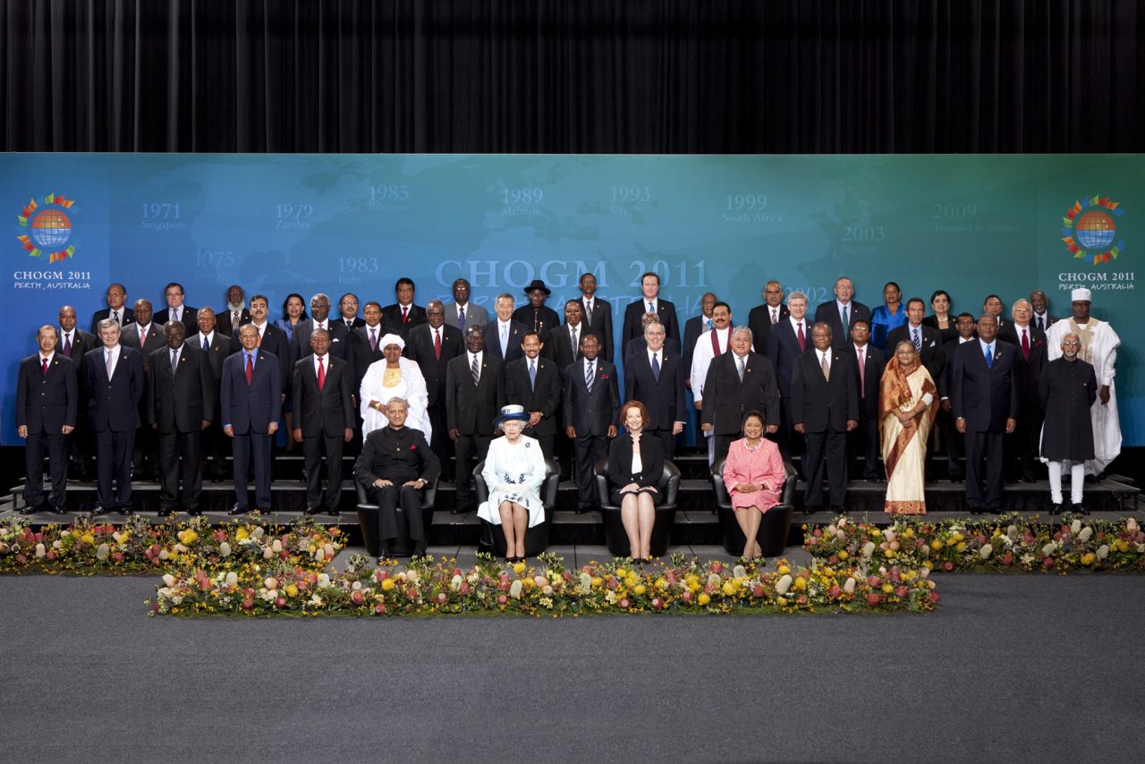 Delegates pose for a group photograph on the stage at CHOGM 2011.