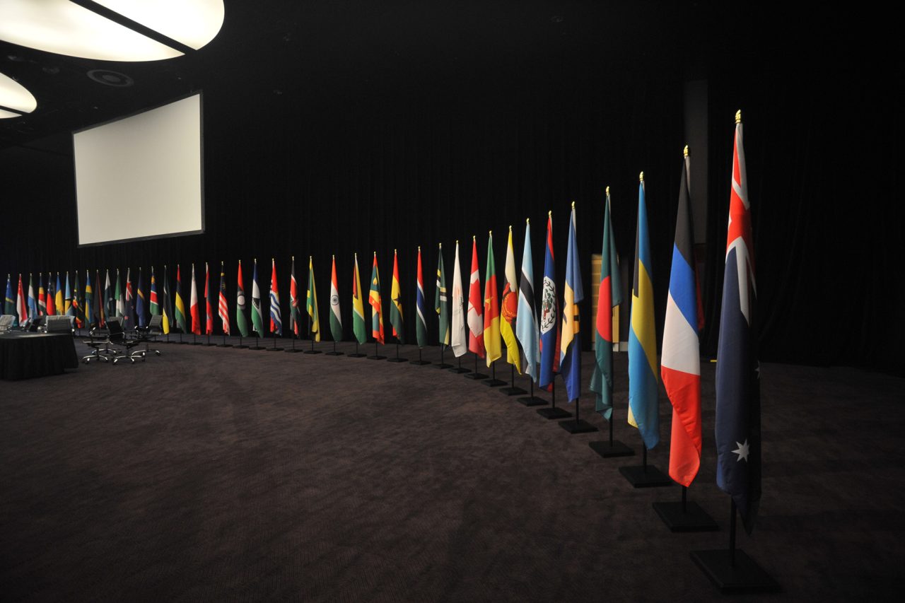 A row of national flags illuminated against a dark backdrop at CHOGM 2011.