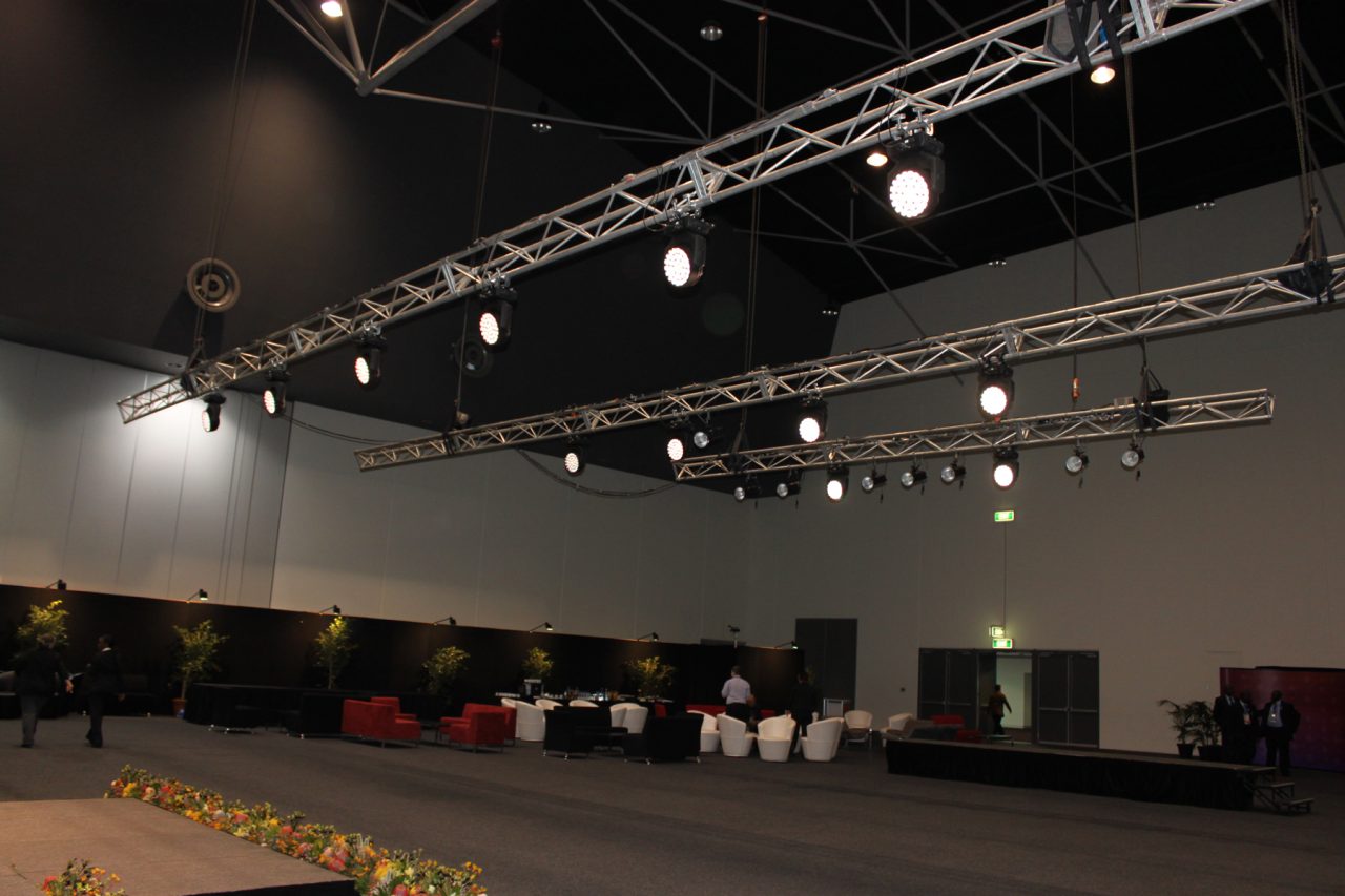 Overhead trusses and lighting fixtures in a CHOGM 2011 event space.