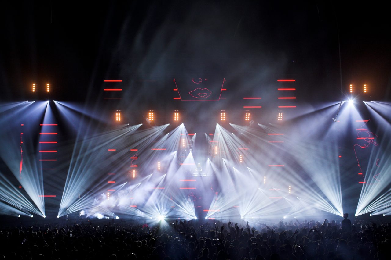 White beams fan across the stage above the crowd at David Guetta's Tasmania show.