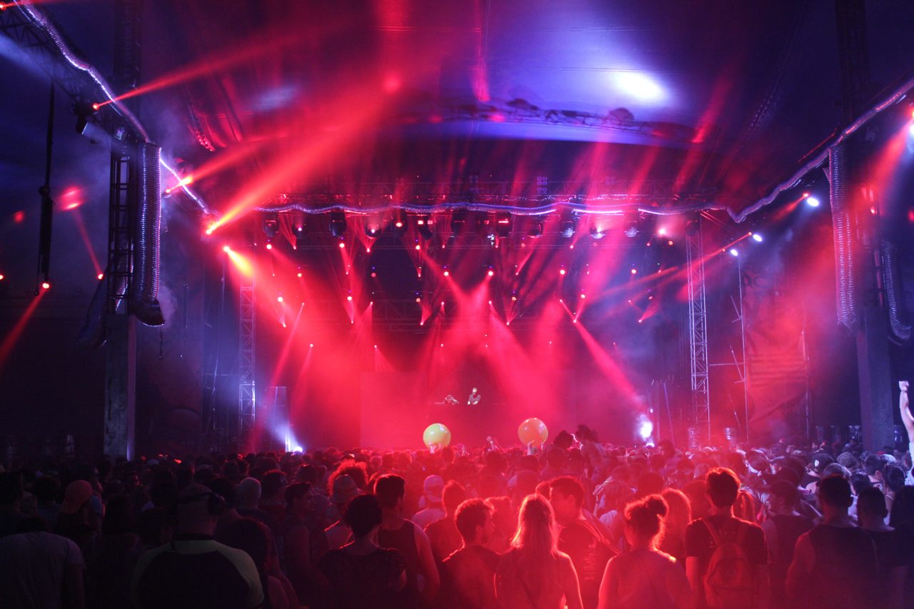 Red and blue stage lighting above the crowd at Future Music Festival.