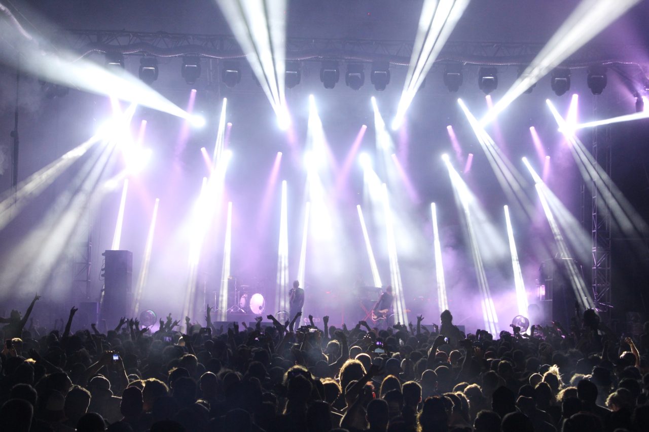 White lighting beams above the audience at Future Music Festival.
