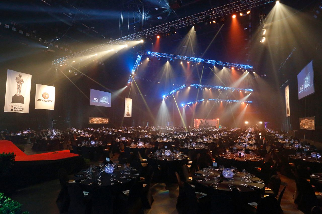 Banquet tables facing the illuminated stage and screens at the Halberg Awards.
