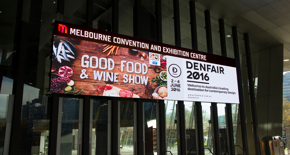 Good Food and Wine Show and Denfair advertisements on the MCEC entrance screen.
