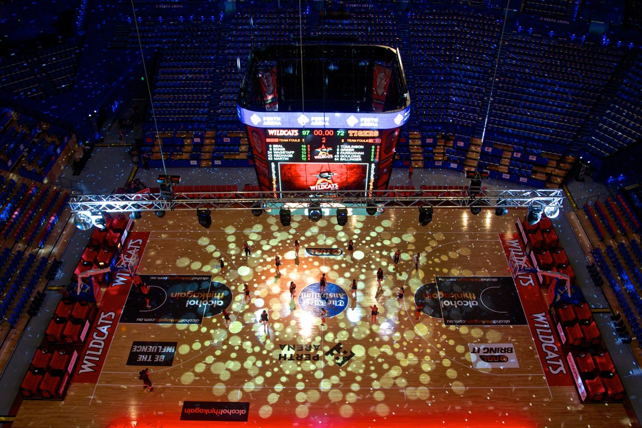 A patterned light show across the Perth Wildcats court and surrounding arena.