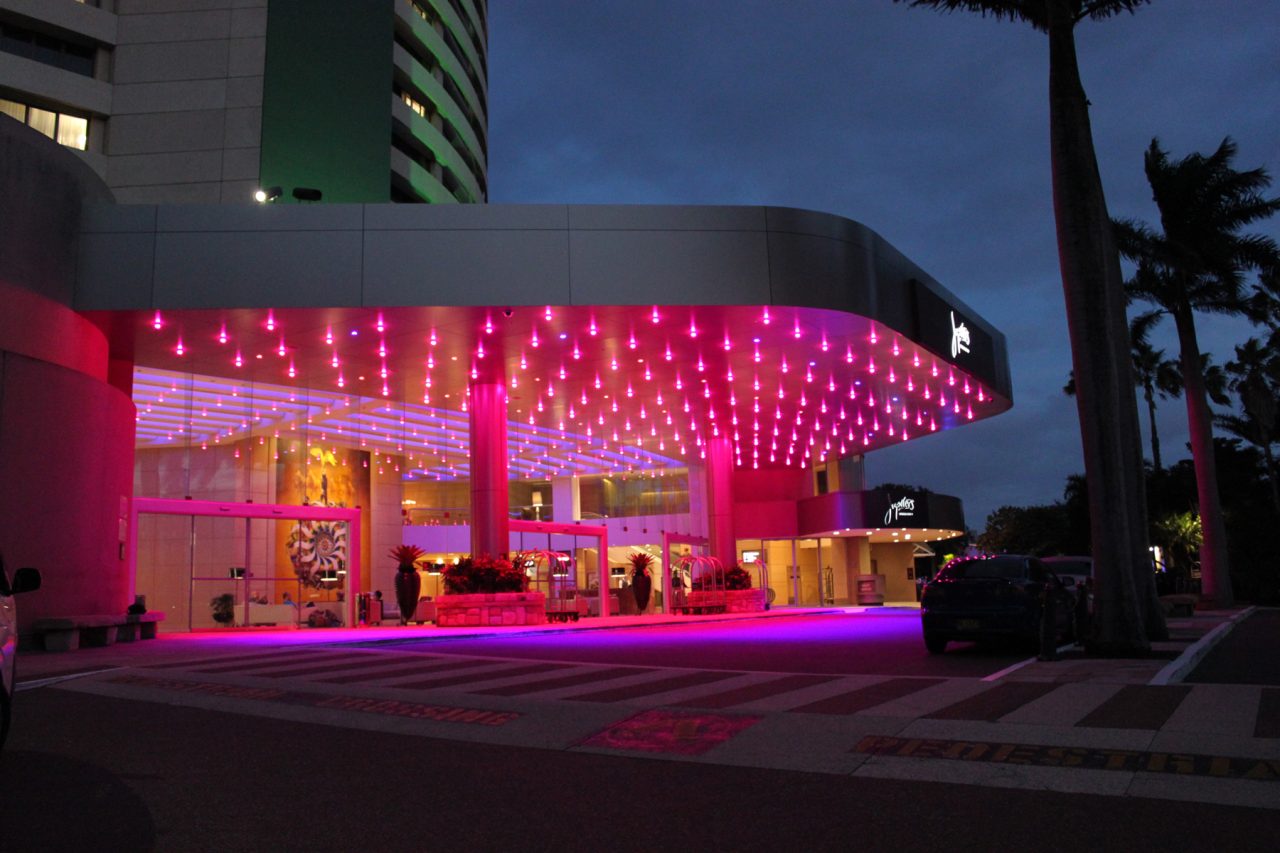 Pink lighting across the entrance canopy at The Star Gold Coast at dusk.