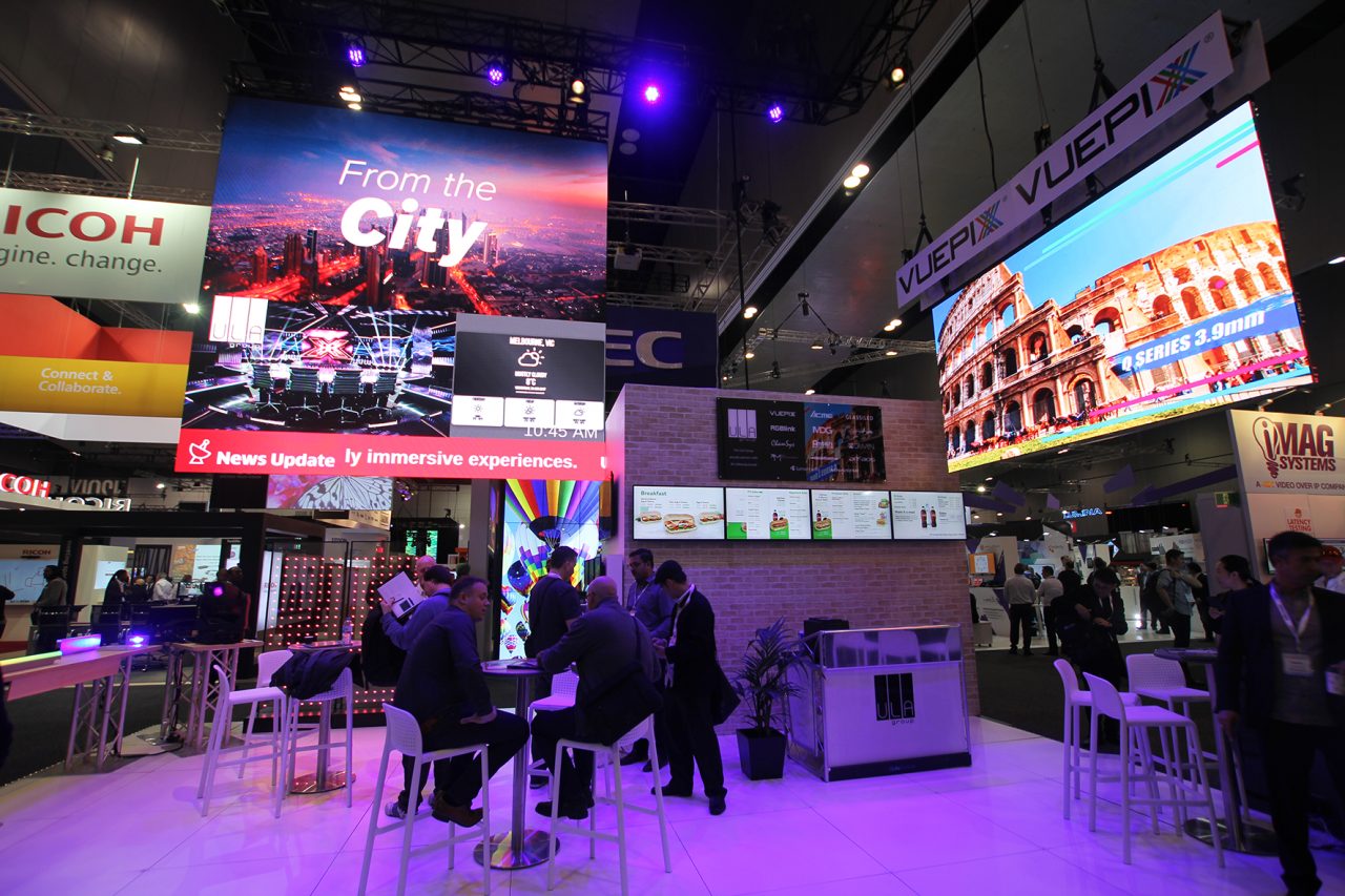 Large digital screens above ULA's exhibition stand at Integrate 2017.