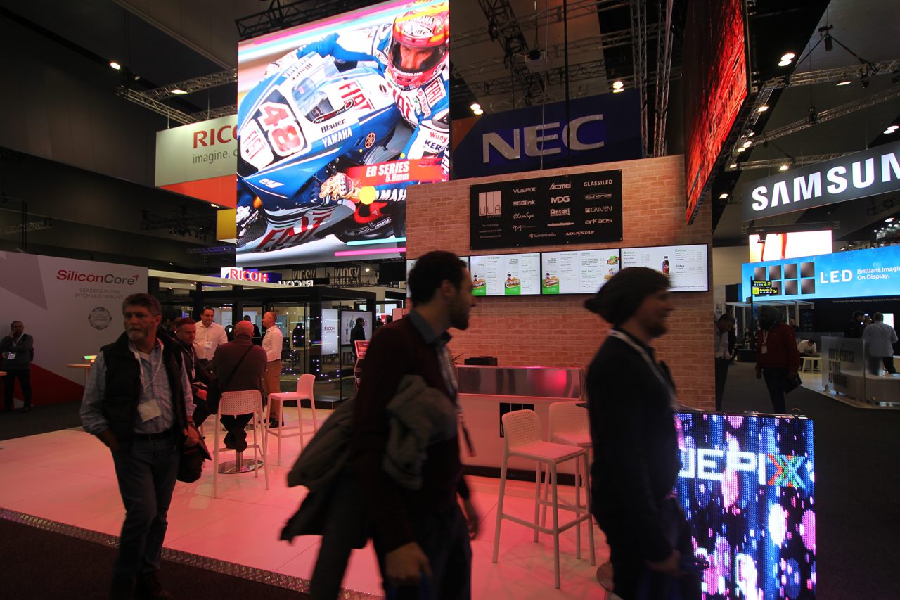 Visitors beside colourful LED displays on ULA's Integrate 2017 stand.