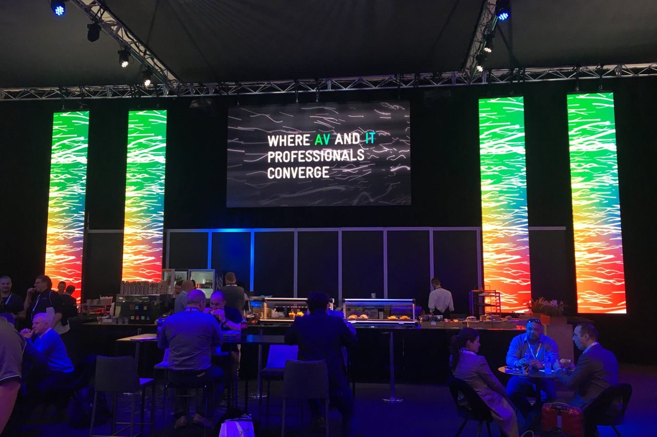 Event stage framed by colourful vertical LED columns at Integrate 2017.