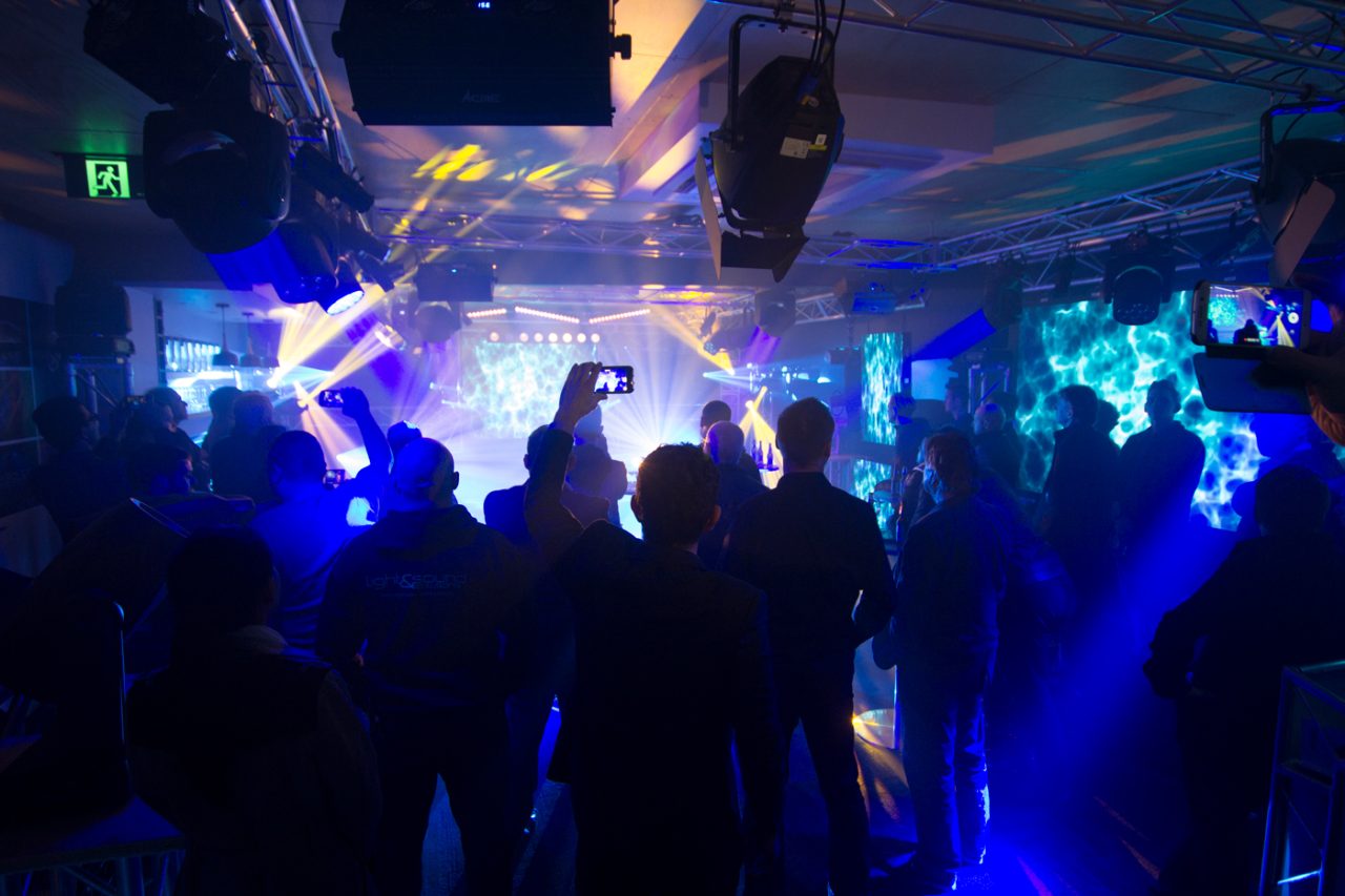 Guests watching blue and white lighting effects at the Melbourne showroom opening.