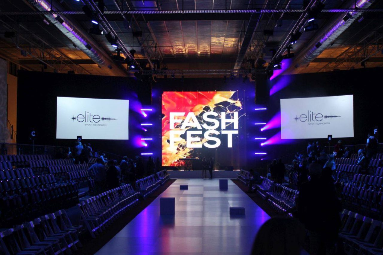 FashFest branding on the central screen at the end of the empty runway.