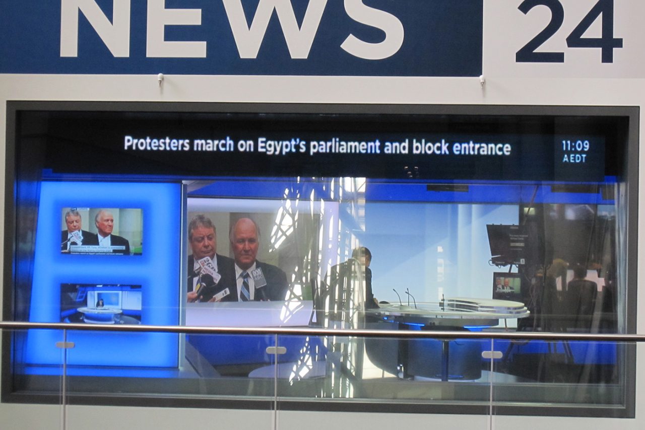 Front view of the ABC News 24 studio and headline ticker.