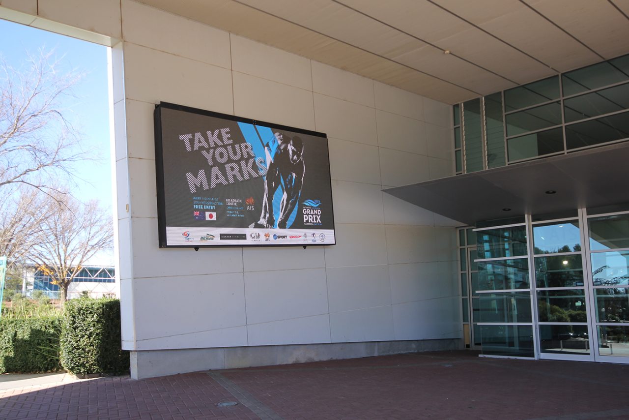 Take Your Mark imagery on the screen at the Australian Institute of Sport entrance.