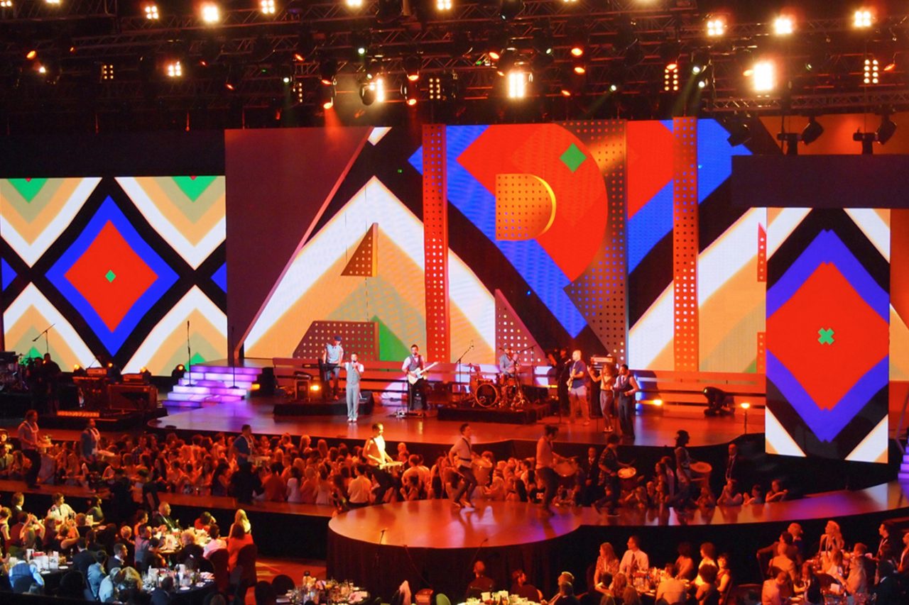 Bright geometric graphics across the ARIA Awards stage screens.