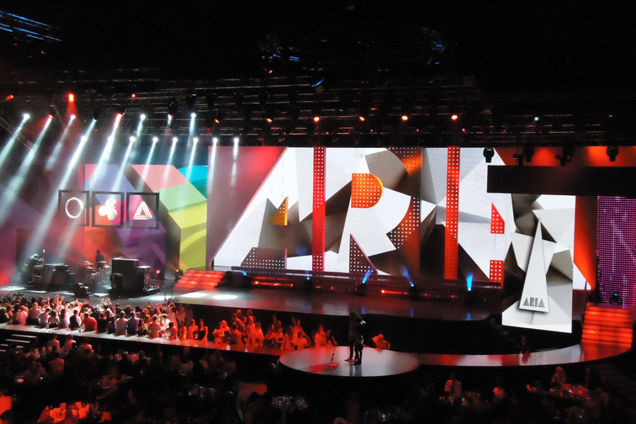 White beams above the ARIA-branded stage screens.
