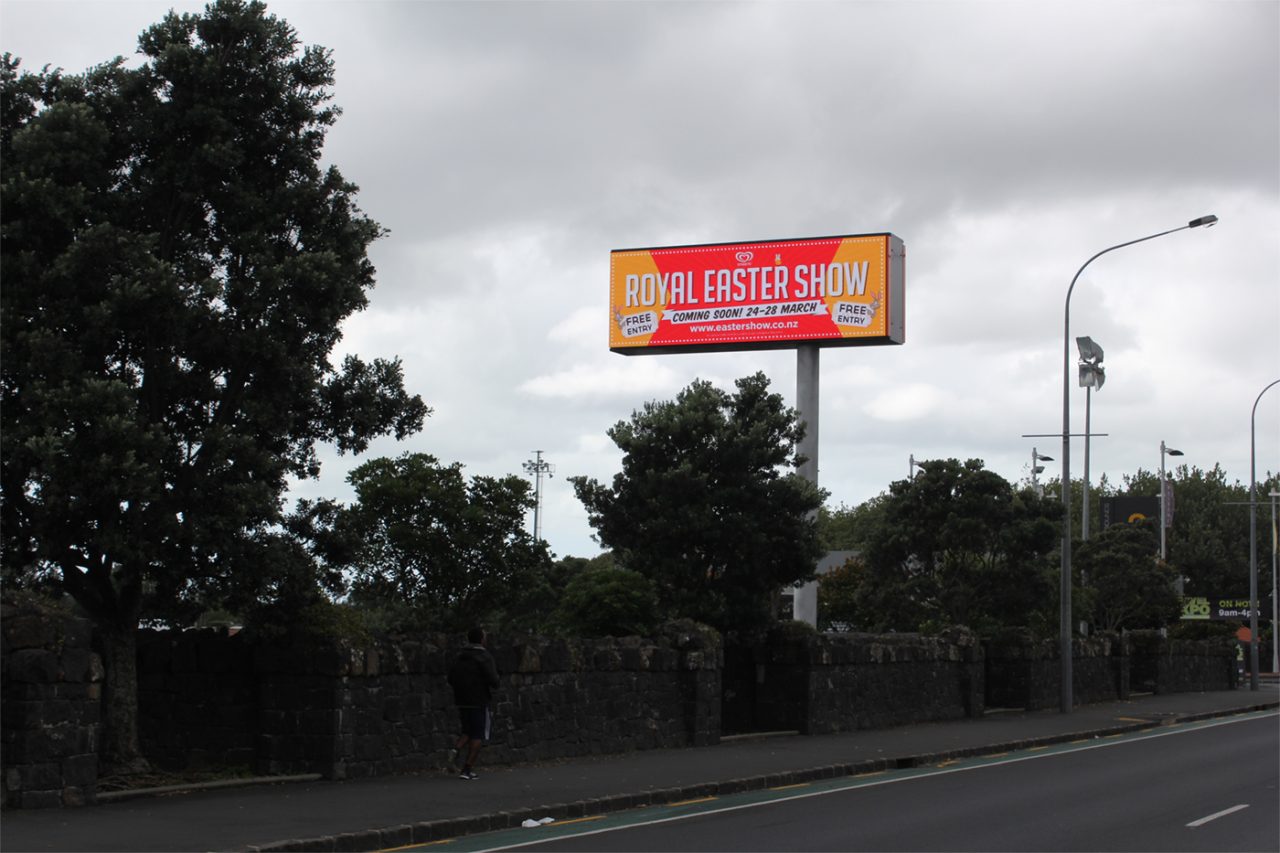 Orange event advertising on the ASB Showgrounds roadside billboard.