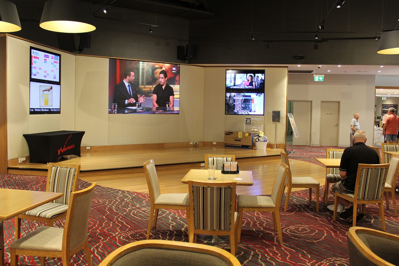 Foyer seating faces the main video screen and side displays at Blacktown Workers Club.