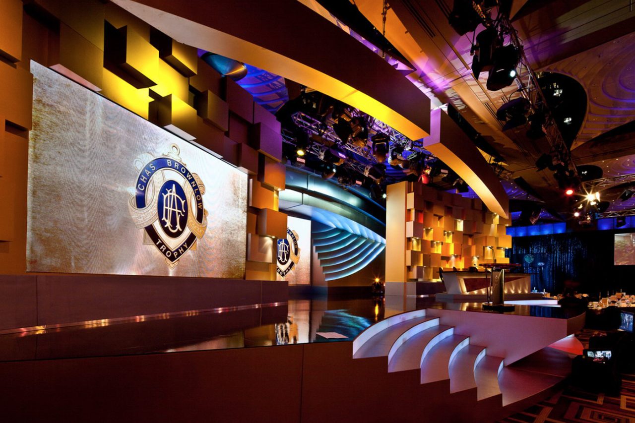 Angled view of the Brownlow Medal stage screens and gold scenic wall.