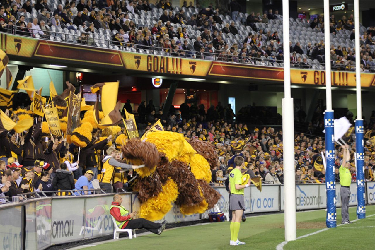 Digital ribbon signage above the goal-end crowd at Etihad Stadium.