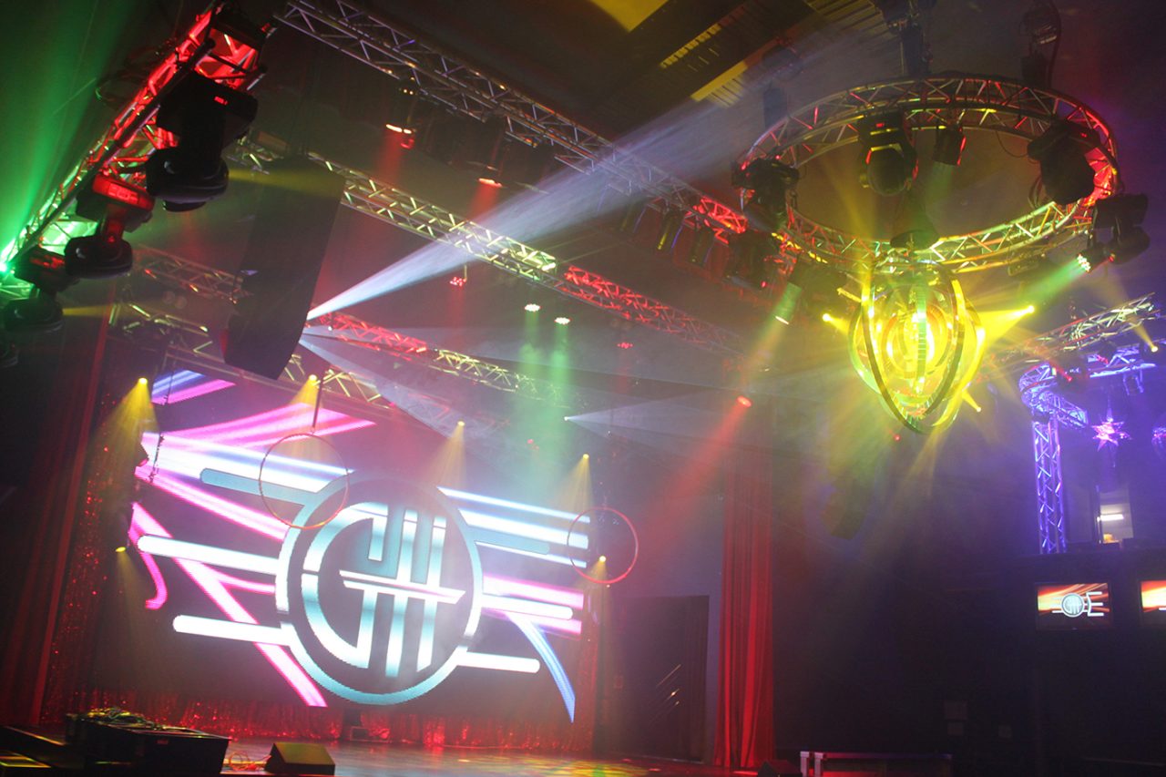 Multicoloured beams above the GH Hotel's illuminated stage logo.
