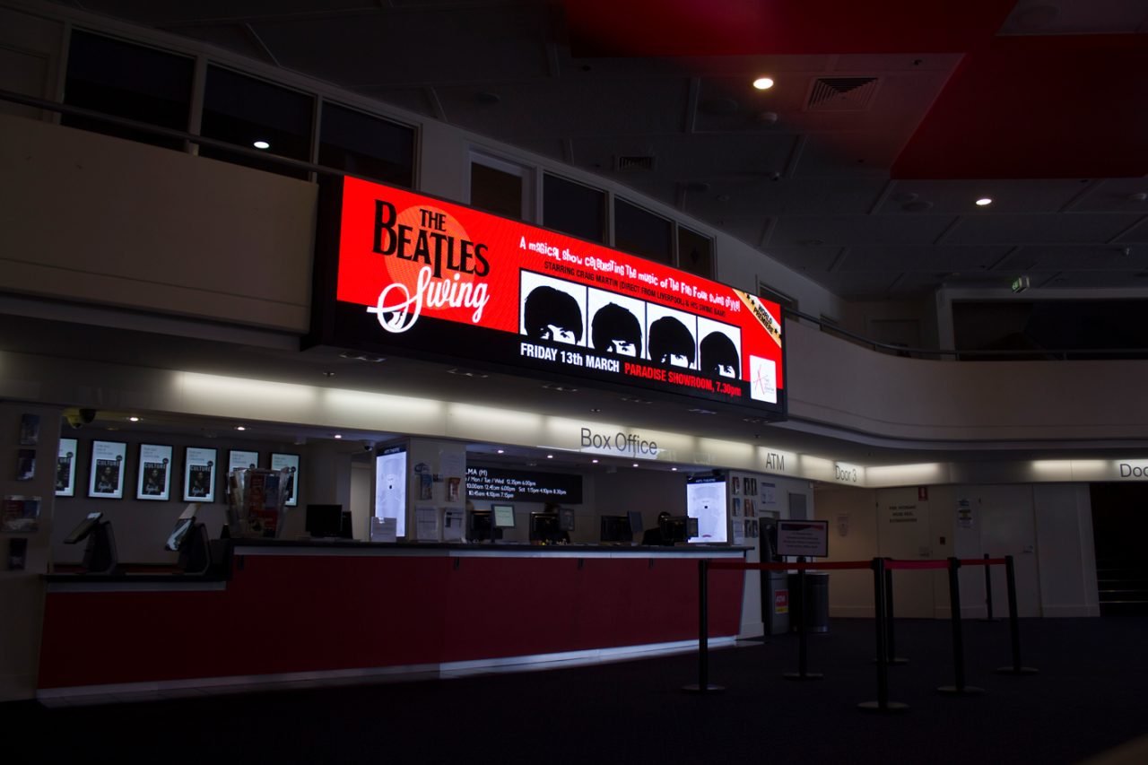 The Beatles Forever promotion on the wide display above the HOTA box office.