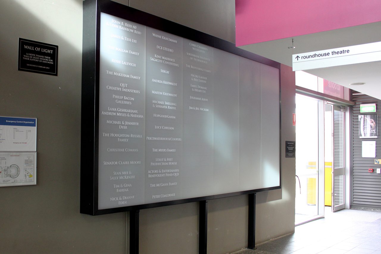 Angled view of the information display beside La Boite Theatre's entrance doors.