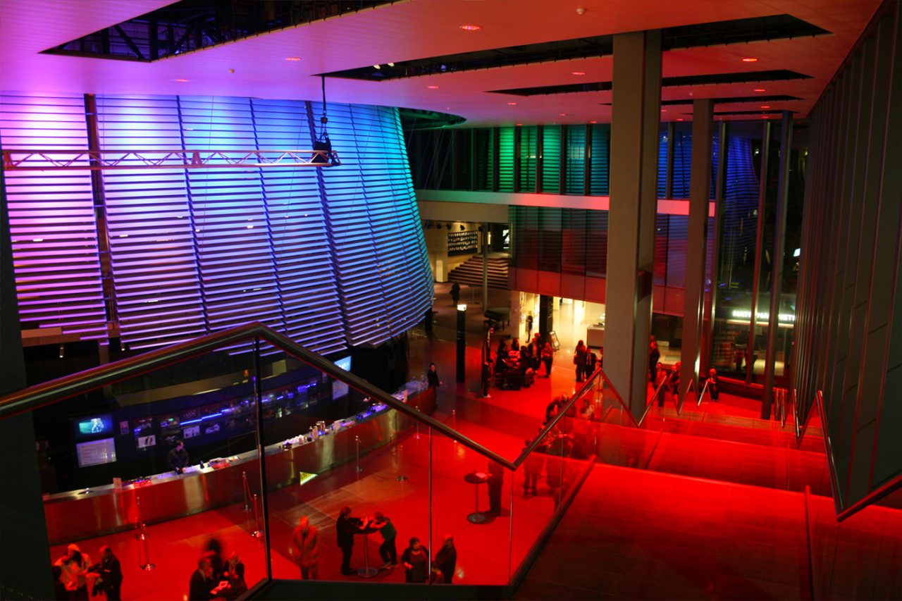 Red floor lighting and blue wall illumination in the NIDA foyer.