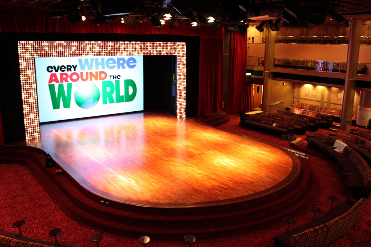Colourful Around the World graphics on the Pacific Dawn theatre screen.
