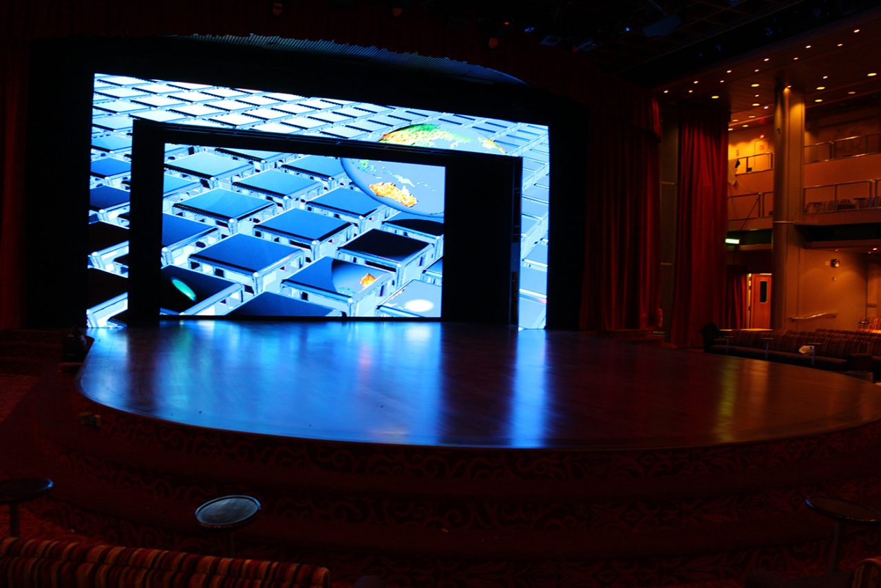 Blue geometric graphics across the Pacific Jewel theatre screens.