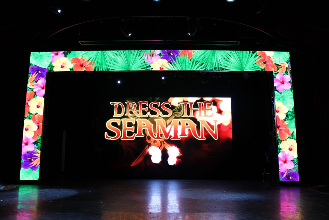 Dress Up Sequin show title on the Pacific Jewel theatre screen, surrounded by a floral border.