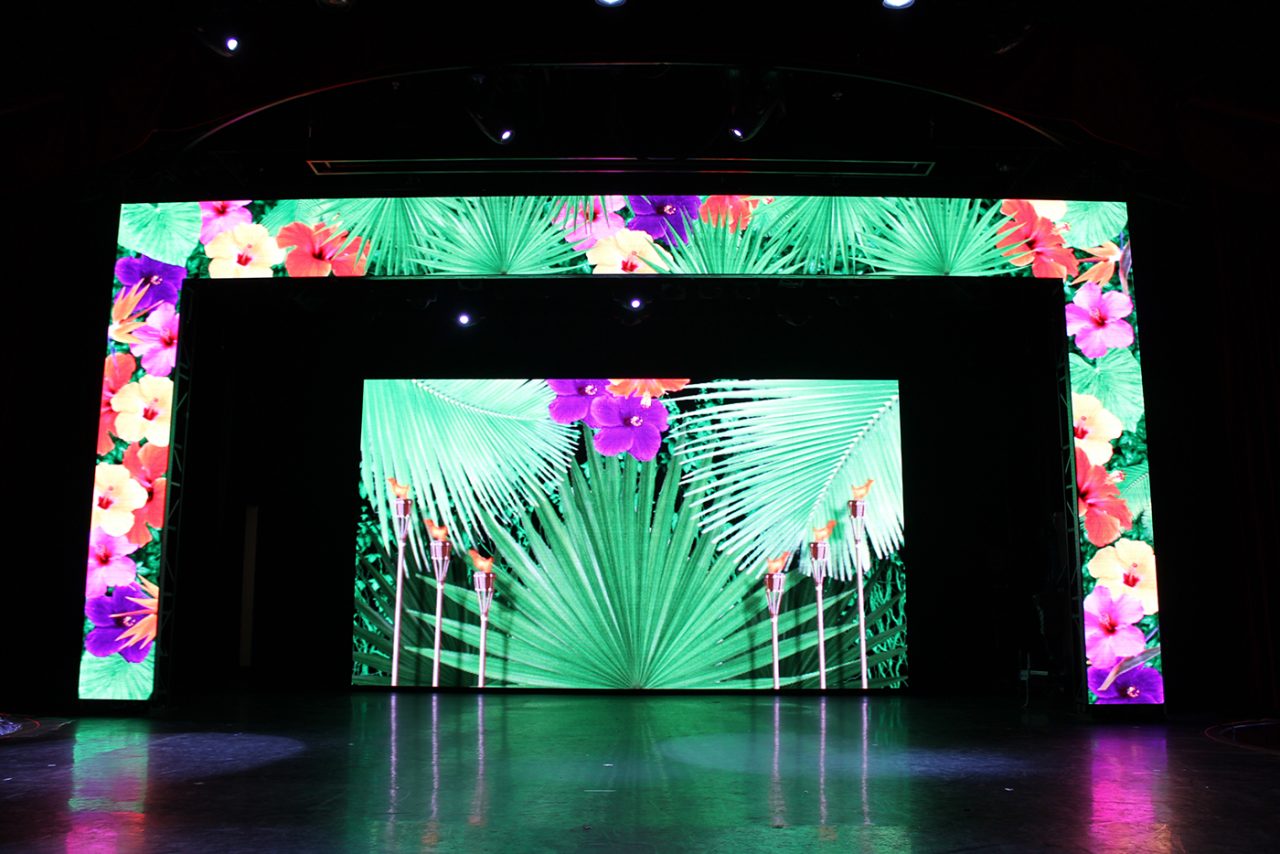 Tropical imagery across the stage screens aboard Pacific Jewel.
