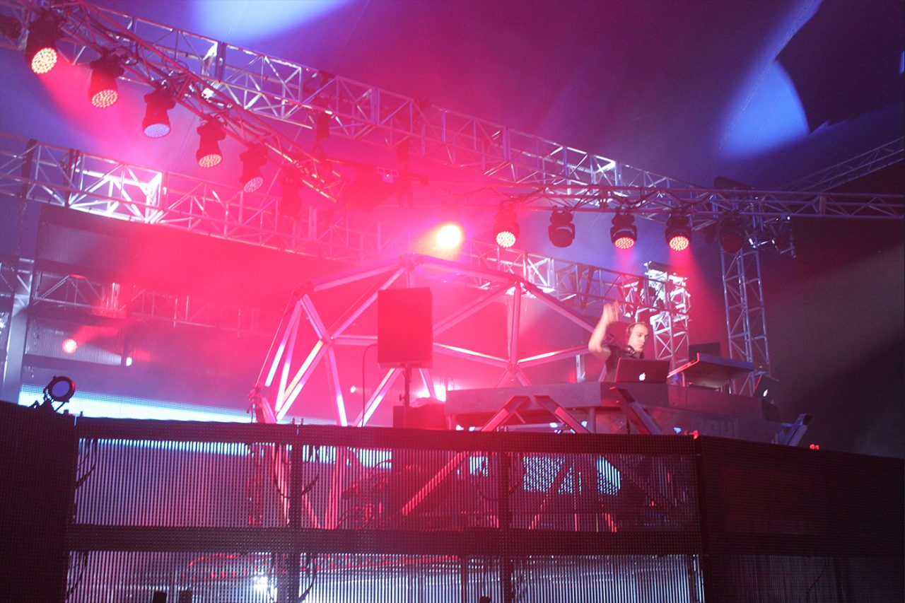 Red lighting around the DJ platform at a Paul van Dyk show.