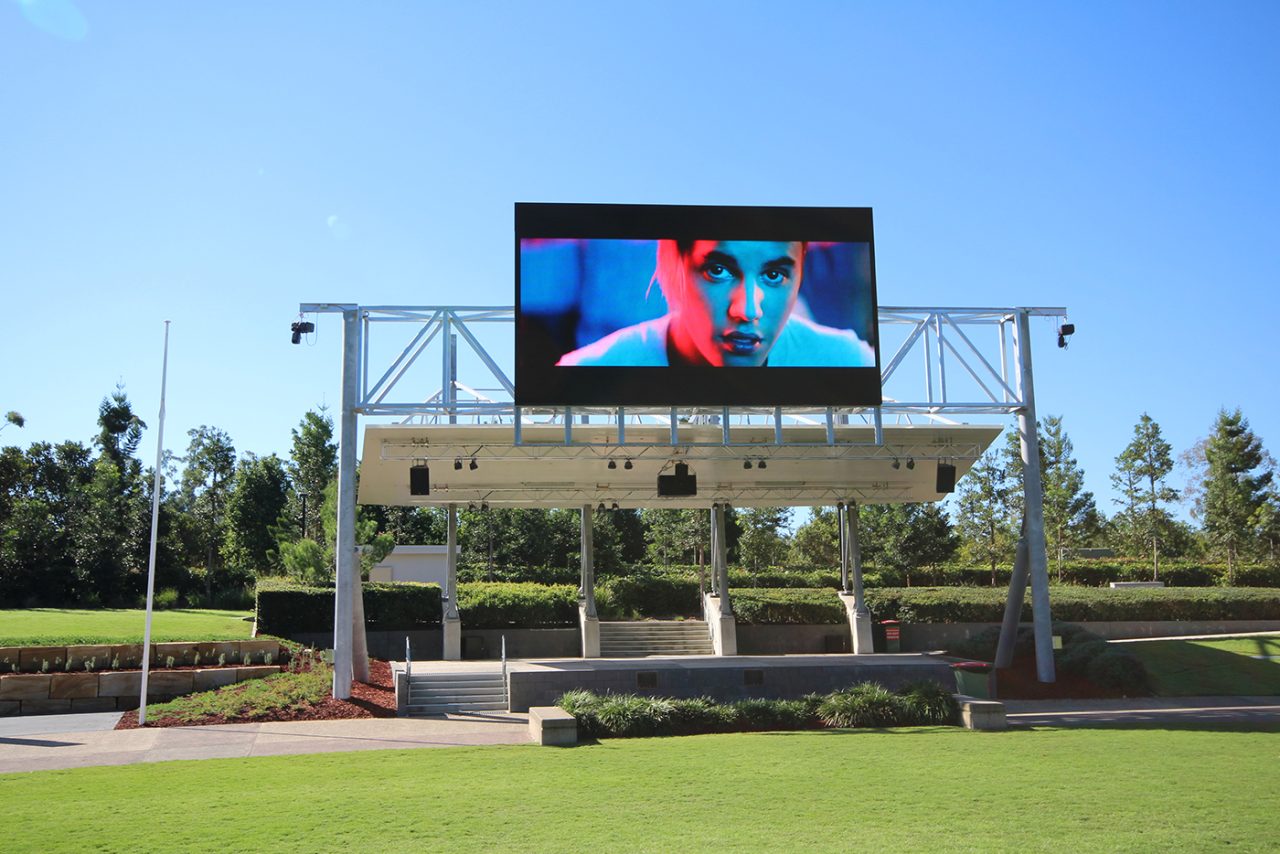 Performance footage on the digital screen above Robelle Domain's lawn.