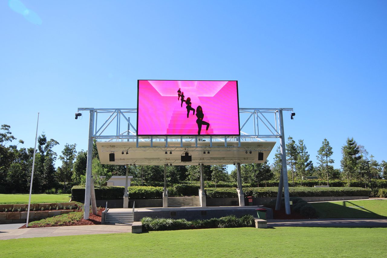 Pink video imagery on the elevated outdoor screen at Robelle Domain.