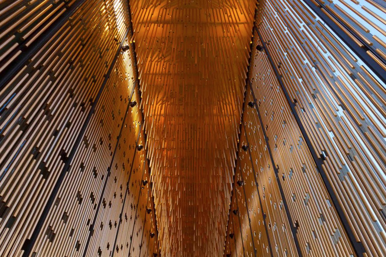 Looking up through the gold-toned hanging elements at the State Theatre Centre of Western Australia.
