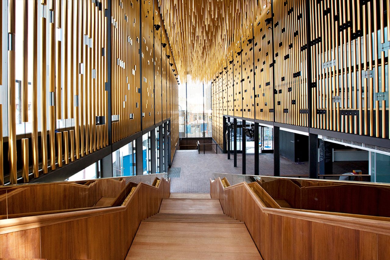 Gold-toned hanging elements above the foyer stairs at the State Theatre Centre of Western Australia.
