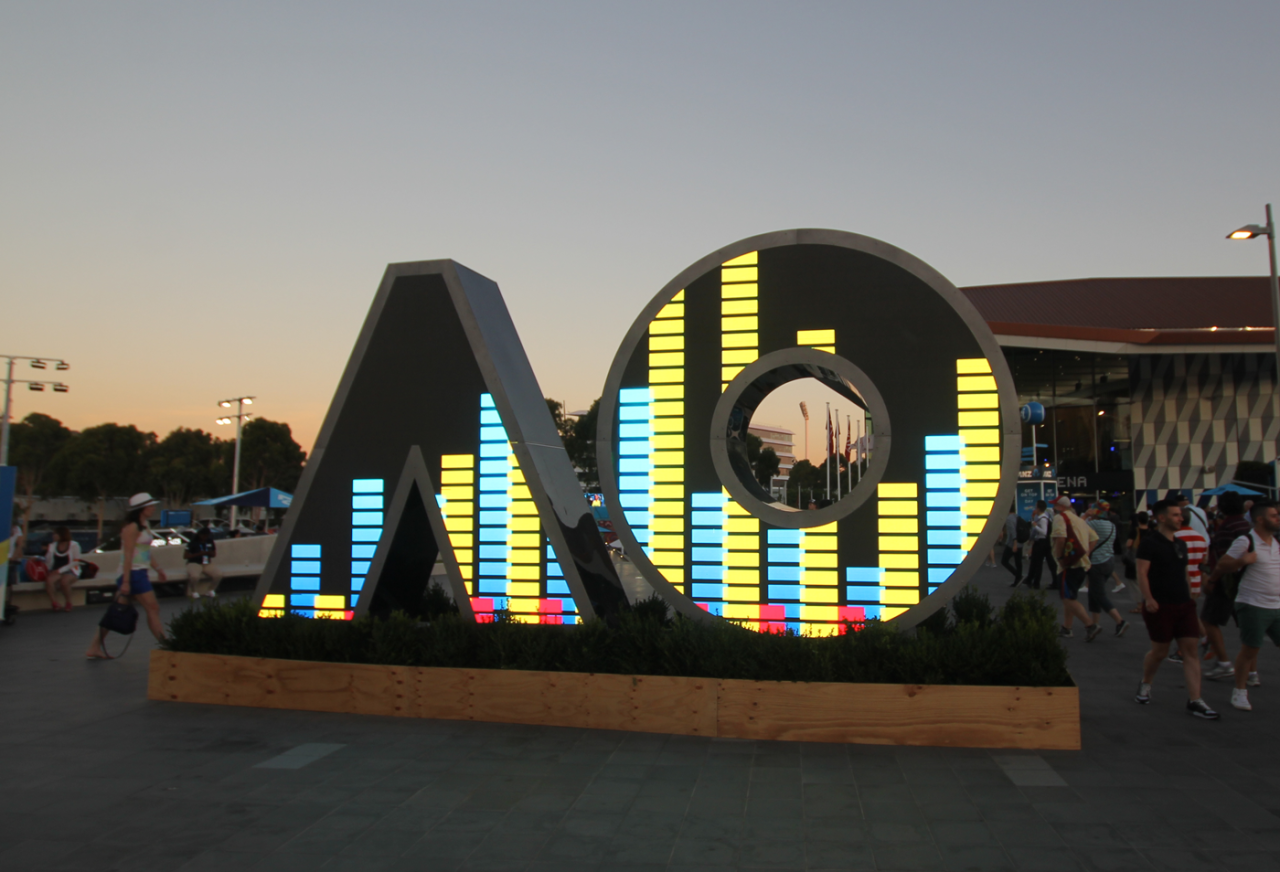 AO-shaped digital sign displaying colourful equaliser-style bars.