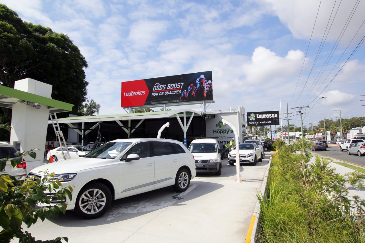 Red advertising on the digital billboard above Hoppy's car wash.