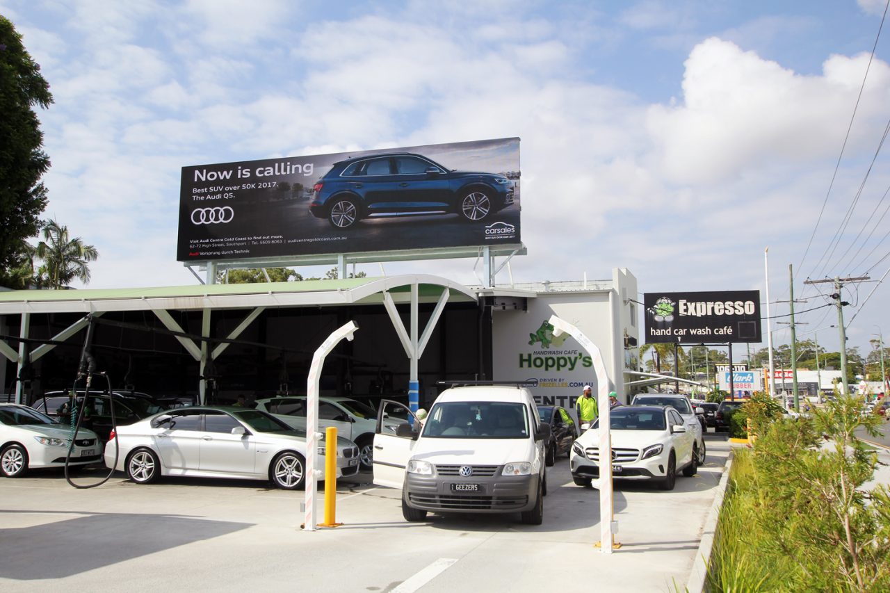 Car advertisement on the digital billboard above Hoppy's car wash.