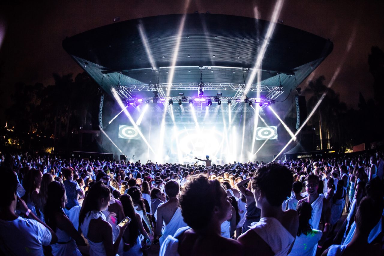 White beams fan across the stage above the Togafest crowd.