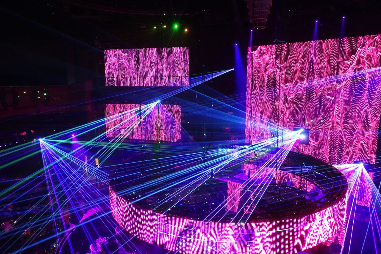 Curved pink LED screens and crossing blue lasers at Cove Manila.