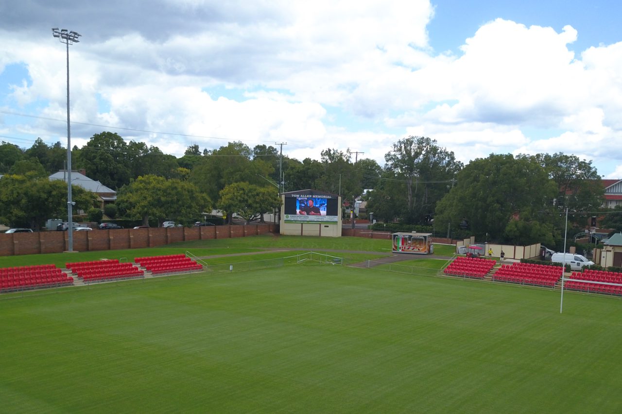 Wide view across Toowoomba Sports Ground toward the digital scoreboard.