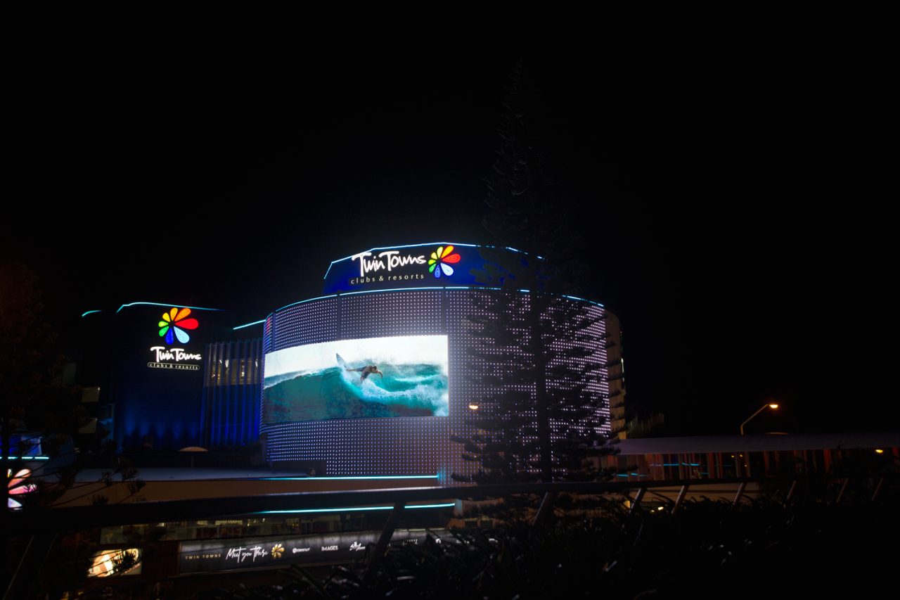 Blue and white imagery on the curved Twin Towns media facade.