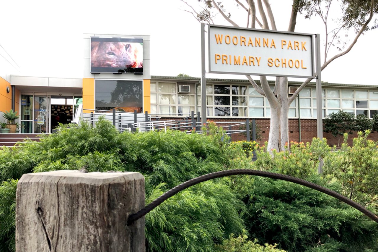 Wooranna Park Primary School entrance sign with a digital screen behind.