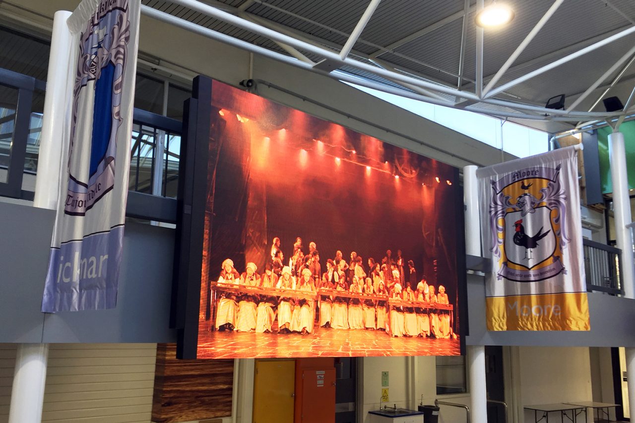 Large school LED display showing a stage performance at Carey Baptist Grammar.